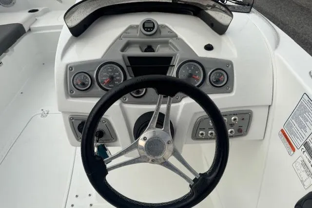 Slide: The Image of Steering console of a 2018 Tahoe 1950 boat with gauges and controls. - 13