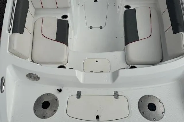 Slide: The Image of Interior of a 2018 Tahoe 1950 boat with white and gray seating. - 7