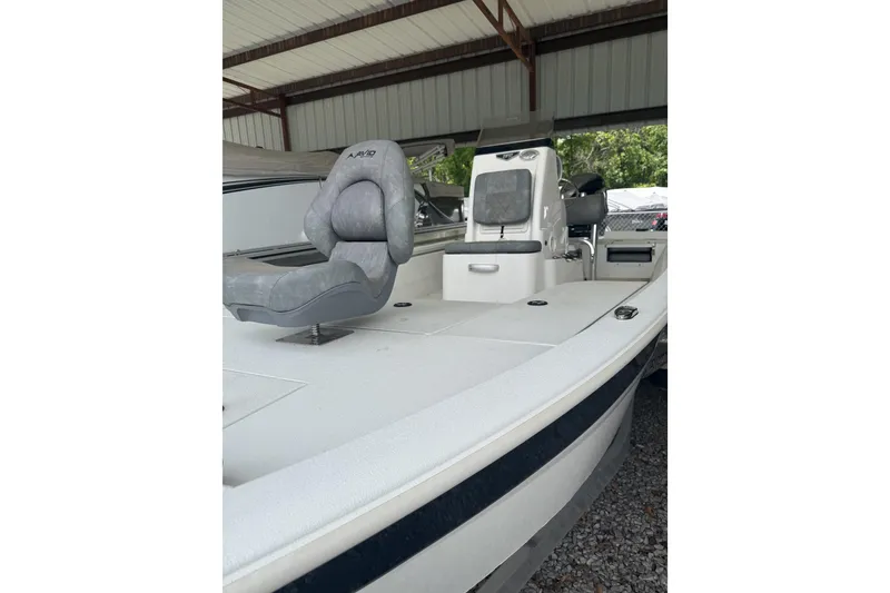 Slide: The Image of 2024 Avid 21 FST boat with gray seating under a metal canopy. - 1