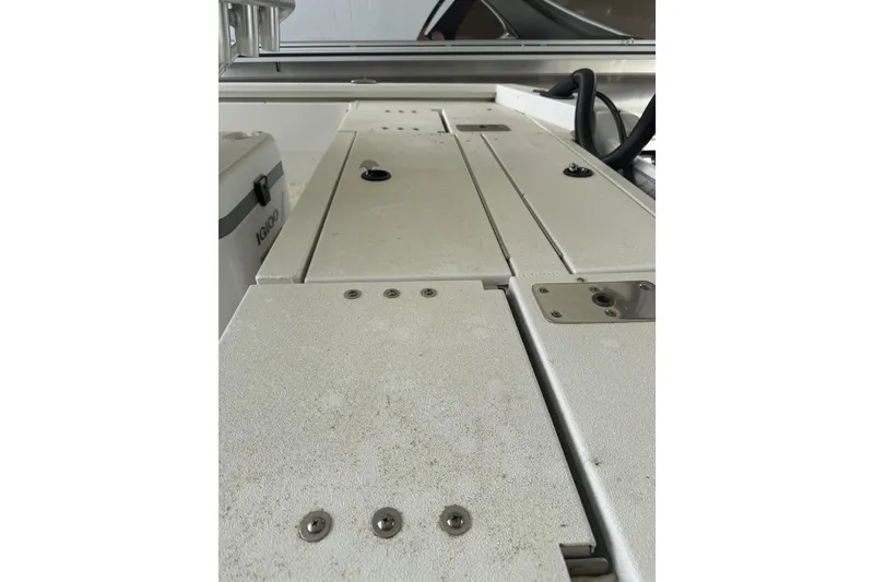 Slide: The Image of 2024 Avid 21 FST boat interior with storage compartments and cooler. - 16