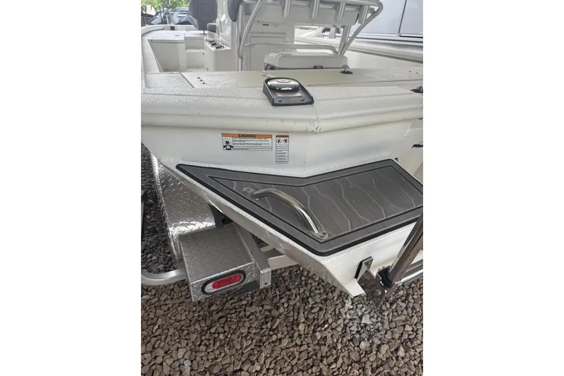 Slide: The Image of 2024 Avid 21 FST boat rear view with step and handle detail. - 4
