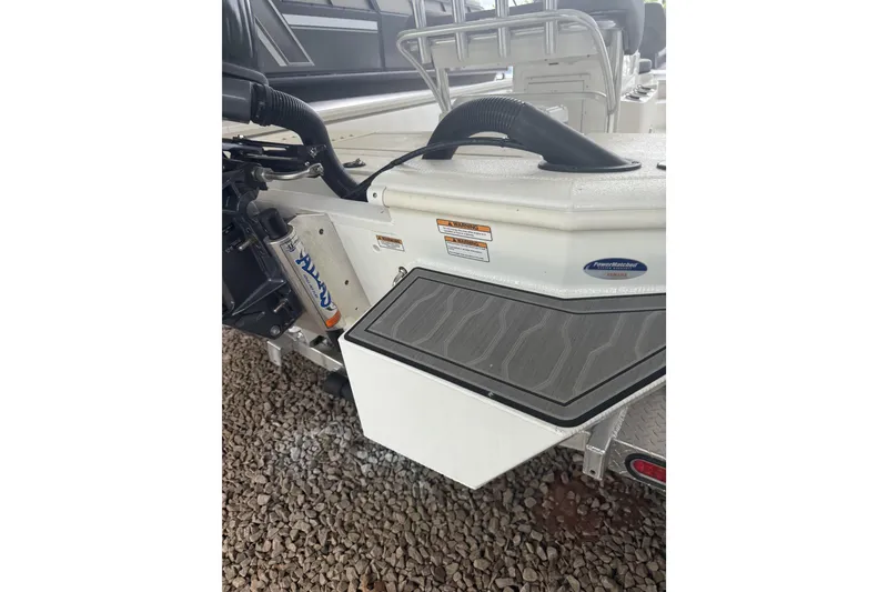 Slide: The Image of 2024 Avid 21 FST boat rear view with motor and deck details. - 5