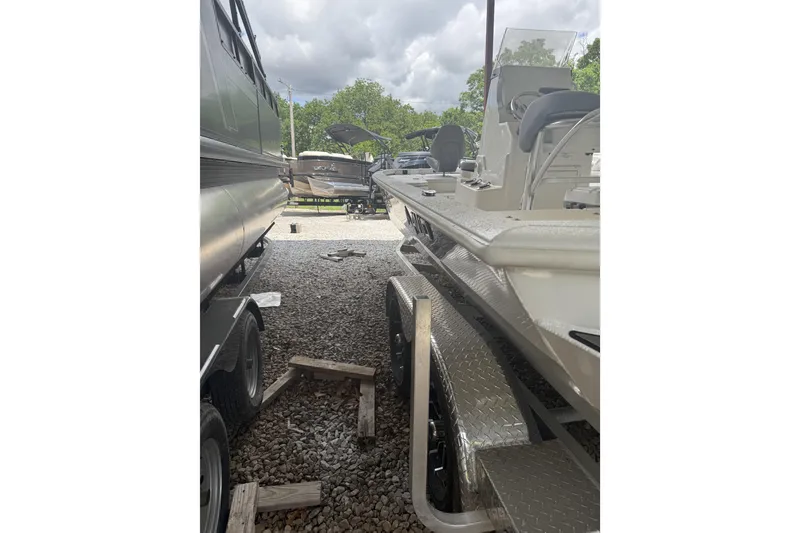Slide: The Image of 2024 Avid 21 FST boat on trailer, parked outdoors under cloudy sky. - 6