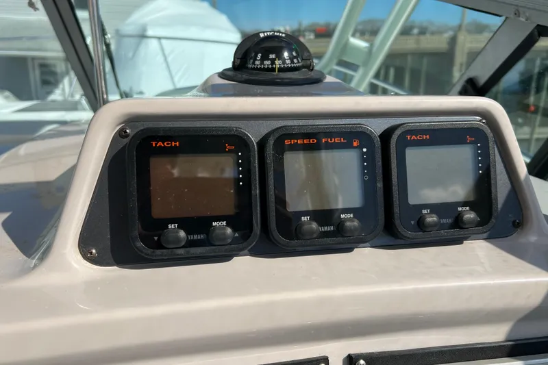 Slide: The Image of 2007 Robalo R305 Walkaround dashboard with Yamaha tachometers and speed fuel gauges. - 11