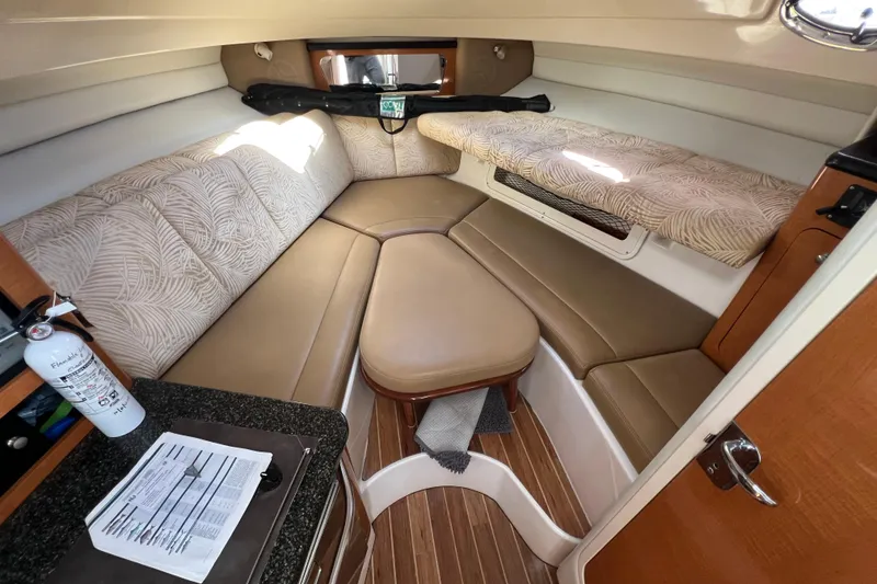 Slide: The Image of 2007 Robalo R305 Walkaround cabin interior with seating and wooden flooring. - 13