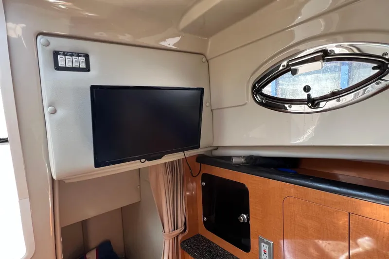 Slide: The Image of 2007 Robalo R305 Walkaround cabin interior with TV and porthole window. - 17