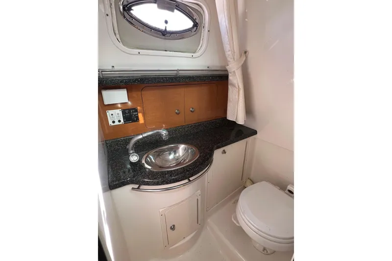 Slide: The Image of 2007 Robalo R305 Walkaround boat bathroom with sink, countertop, and toilet. - 18