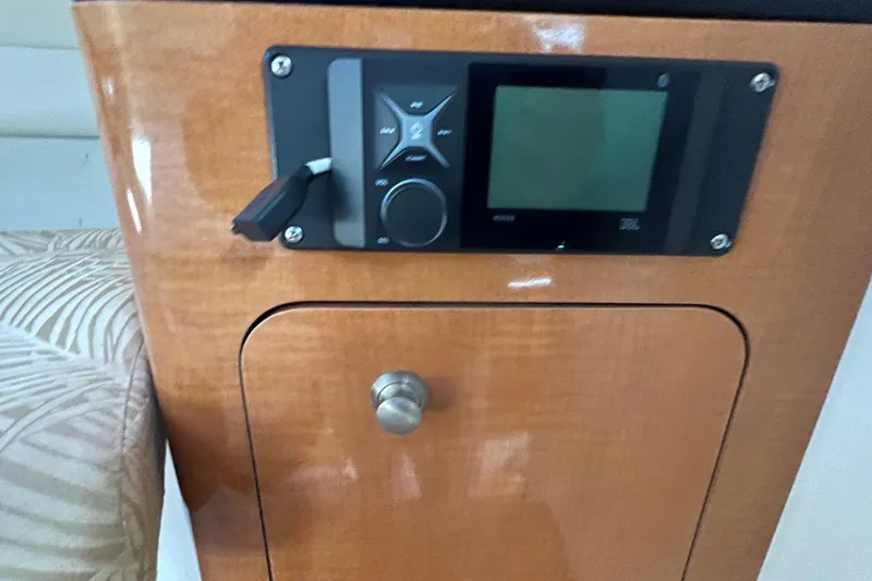 Slide: The Image of 2007 Robalo R305 Walkaround cabin interior with control panel and wooden finish. - 21