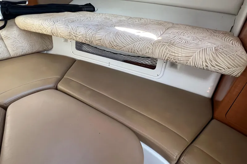Slide: The Image of 2007 Robalo R305 Walkaround cabin interior with beige cushions and patterned upholstery. - 22