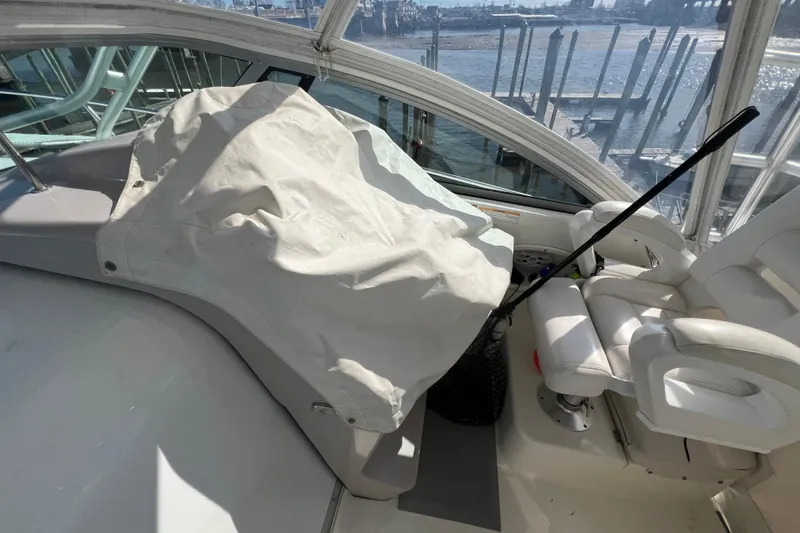 Slide: The Image of 2007 Robalo R305 Walkaround boat interior with covered helm and white seating. - 8