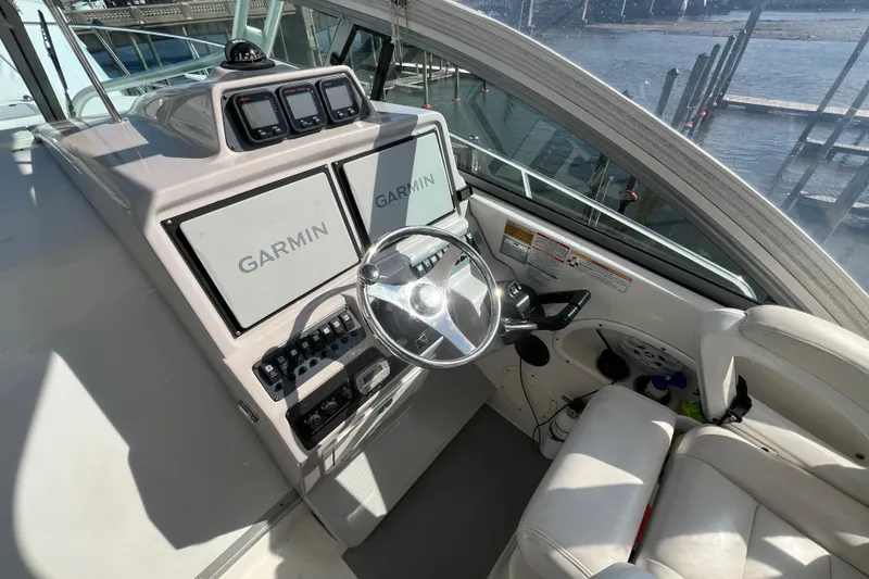 Slide: The Image of 2007 Robalo R305 Walkaround helm with Garmin navigation displays and steering wheel. - 9