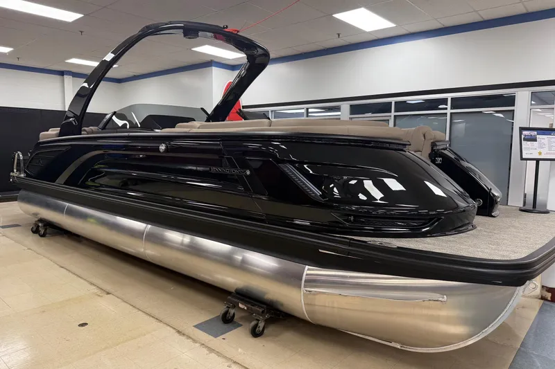 The Image of 2026 Bennington 25 QX Quad Bench pontoon boat displayed indoors. - 0