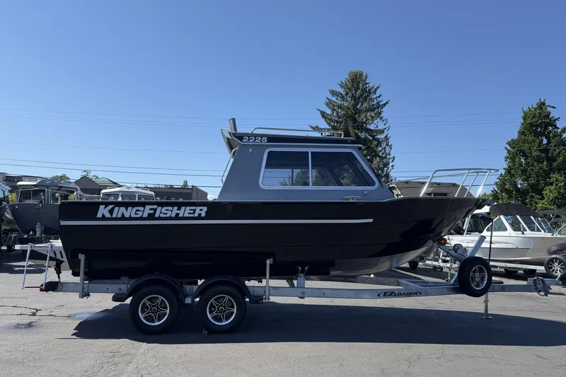 The Image of 2025 KingFisher 2225 Escape HT boat on trailer, black exterior, parked outdoors. - 0