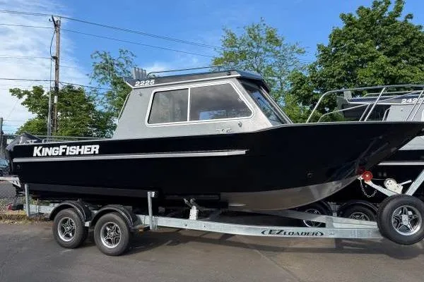 The Image of 2025 KingFisher 2225 Escape HT boat on trailer, black exterior, parked outdoors. - 1