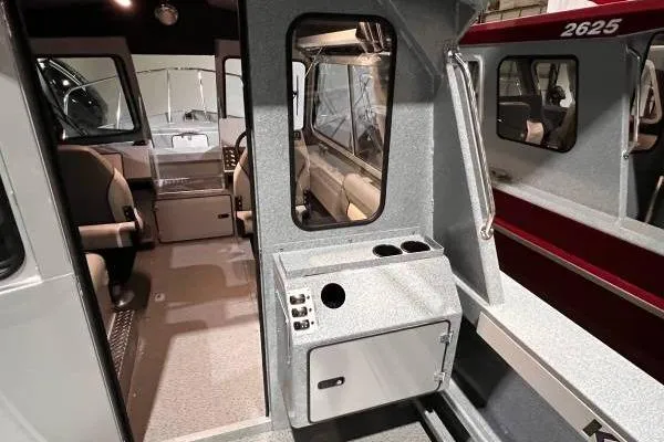 Slide: The Image of Interior view of 2025 KingFisher 2225 Escape HT boat, showcasing seating and control panel. - 11