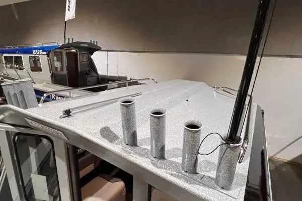 Slide: The Image of 2025 KingFisher 2225 Escape HT boat roof with rod holders in showroom. - 14