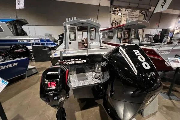 Slide: The Image of 2025 KingFisher 2225 Escape HT boat with Mercury outboard motors displayed indoors. - 5