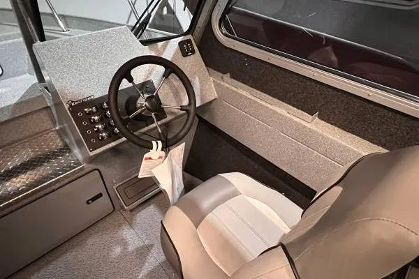 Slide: The Image of Interior of 2025 KingFisher 2225 Escape HT boat, featuring steering wheel and control panel. - 6