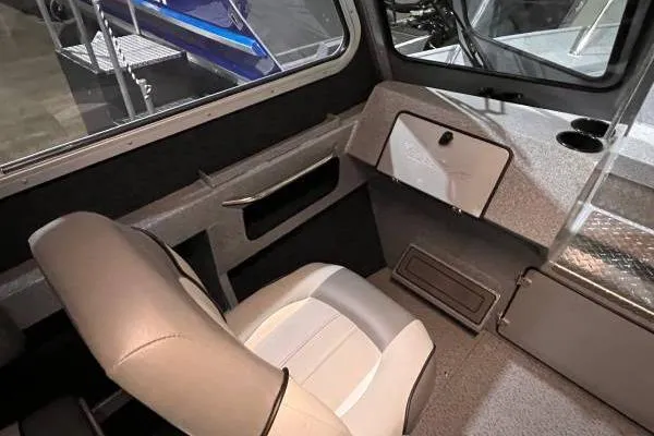 Slide: The Image of Interior of 2025 KingFisher 2225 Escape HT boat, featuring seating and dashboard. - 7