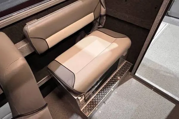 Slide: The Image of Interior seating of 2025 KingFisher 2225 Escape HT boat, featuring cushioned bench and metallic flooring. - 9
