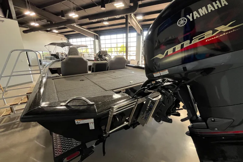 Slide: The Image of 2024 Avid 19 XB boat with Yamaha VMAX engine in showroom setting. - 3