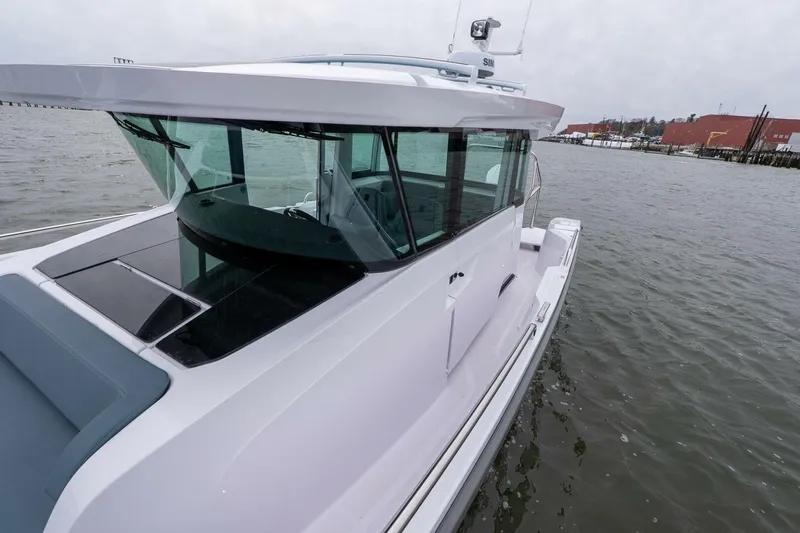 Slide: The Image of 2026 Axopar 29 XC Cross Cabin boat on water, showcasing sleek design and modern features. - 10