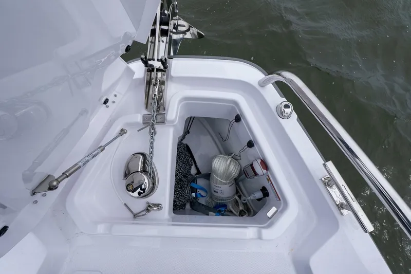 Slide: The Image of Anchor compartment of 2026 Axopar 29 XC Cross Cabin with marine equipment. - 13