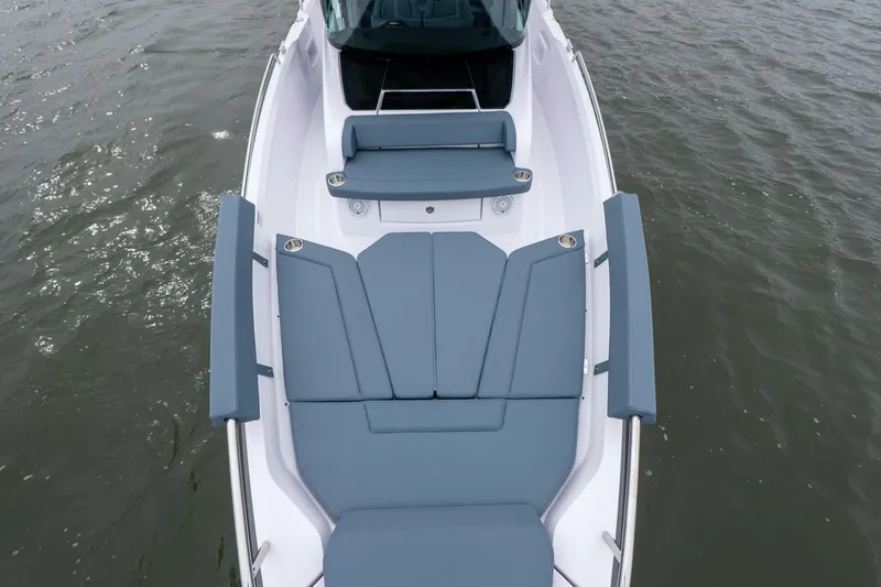 Slide: The Image of 2026 Axopar 29 XC Cross Cabin boat with sleek seating on calm water. - 15