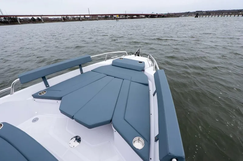 Slide: The Image of 2026 Axopar 29 XC Cross Cabin boat with blue seating on open water. - 17