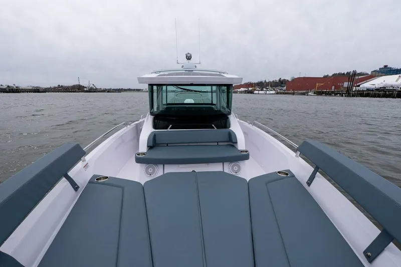 Slide: The Image of 2026 Axopar 29 XC Cross Cabin boat on water, featuring spacious seating and sleek design. - 18