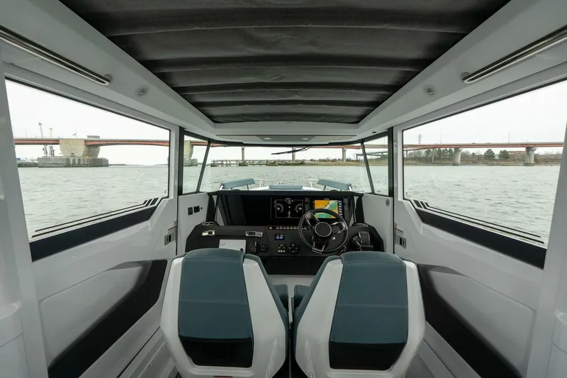 Slide: The Image of Interior view of 2026 Axopar 29 XC Cross Cabin boat, featuring modern dashboard and seating. - 20