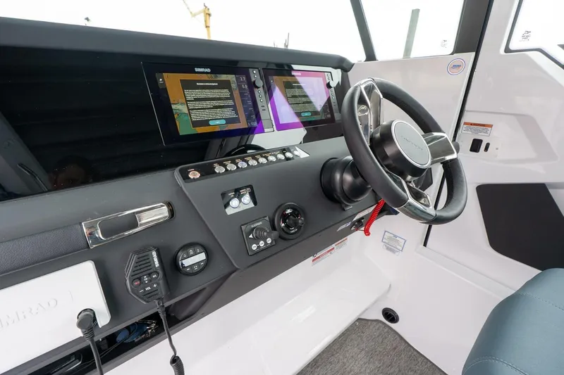 Slide: The Image of 2026 Axopar 29 XC Cross Cabin helm with modern controls and navigation displays. - 22