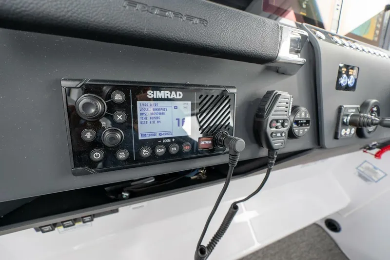 Slide: The Image of Simrad marine radio system on 2026 Axopar 29 XC Cross Cabin dashboard. - 24