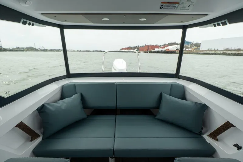 Slide: The Image of Interior view of 2026 Axopar 29 XC Cross Cabin with comfortable seating and panoramic windows. - 25