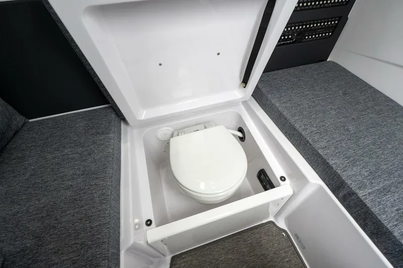 Slide: The Image of 2026 Axopar 29 XC Cross Cabin interior with hidden marine toilet. - 32