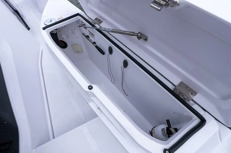 Slide: The Image of Open storage compartment in 2026 Axopar 29 XC Cross Cabin boat. - 7