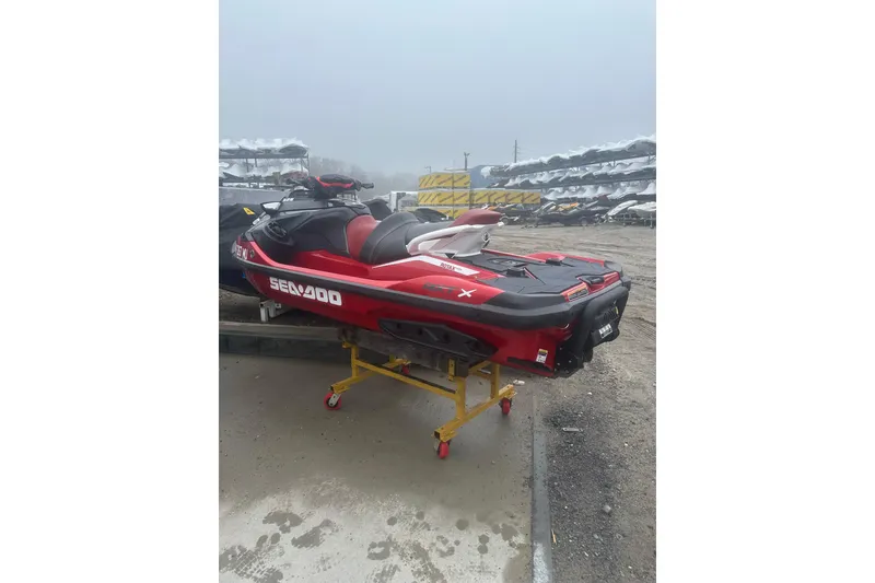 Slide: The Image of 2024 Sea-Doo RXT-X 325 jet ski in red, displayed outdoors on a stand. - 3