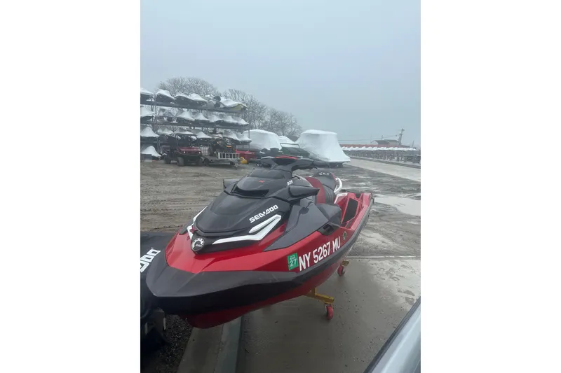 Slide: The Image of 2024 Sea-Doo RXT-X 325 jet ski parked outdoors on a cloudy day. - 5