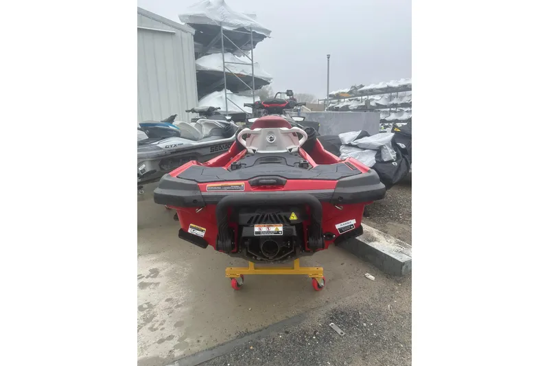 Slide: The Image of 2024 Sea-Doo RXT-X 325 jet ski in storage yard, rear view. - 6