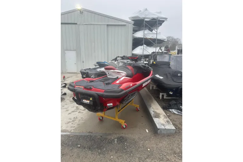 Slide: The Image of 2024 Sea-Doo RXT-X 325 jet ski in storage, red and black design. - 8