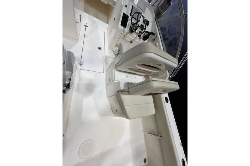 Slide: The Image of 2023 Cobia 220 Dual Console boat interior with seating and steering wheel. - 10