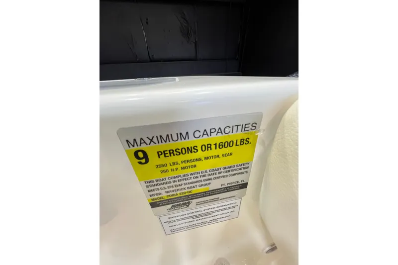 Slide: The Image of 2023 Cobia 220 Dual Console capacity label, maximum 9 persons or 1600 lbs. - 7