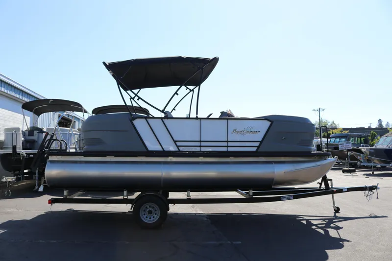 The Image of 2025 SunChaser Lucerne 20 LR DH pontoon boat on trailer, outdoor display. - 1