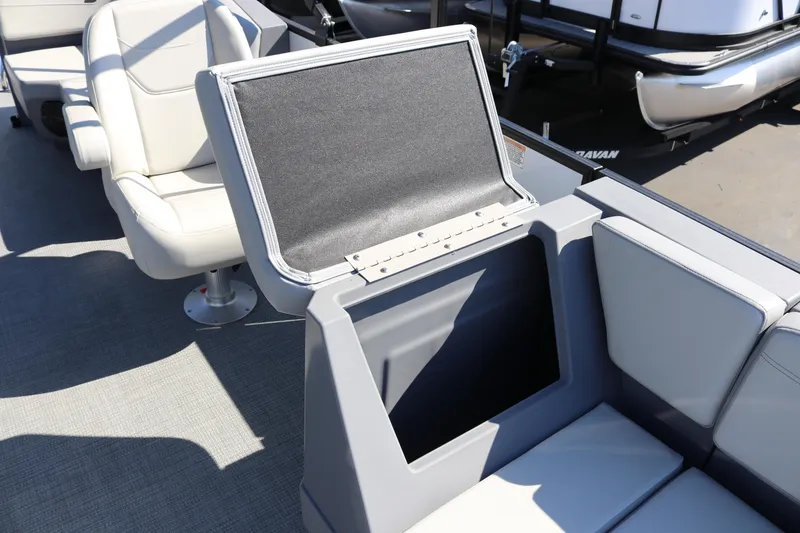 Slide: The Image of 2025 SunChaser Lucerne 20 LR DH boat interior with open storage compartment and seating. - 17