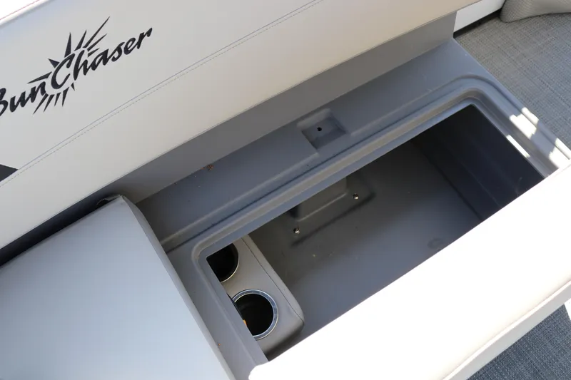 Slide: The Image of SunChaser Lucerne 20 LR DH 2025 boat storage compartment with cup holders. - 31