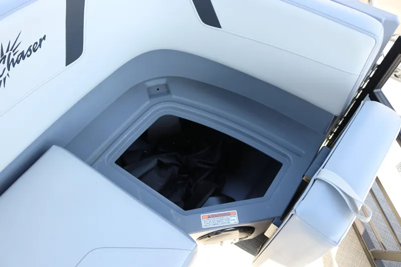 Slide: The Image of SunChaser Lucerne 20 LR DH 2025 boat seat storage compartment, open with visible interior. - 33