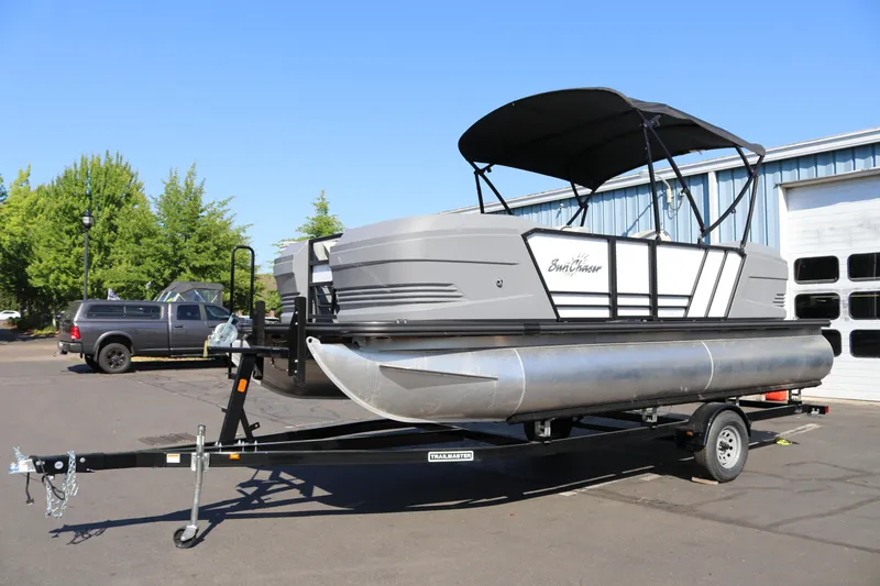 Slide: The Image of 2025 SunChaser Lucerne 20 LR DH pontoon boat on trailer, parked outdoors. - 35
