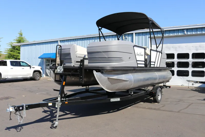 Slide: The Image of 2025 SunChaser Lucerne 20 LR DH pontoon boat on trailer, parked outdoors. - 4