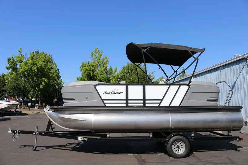 Slide: The Image of 2025 SunChaser Lucerne 20 LR DH pontoon boat on trailer, parked outdoors. - 5