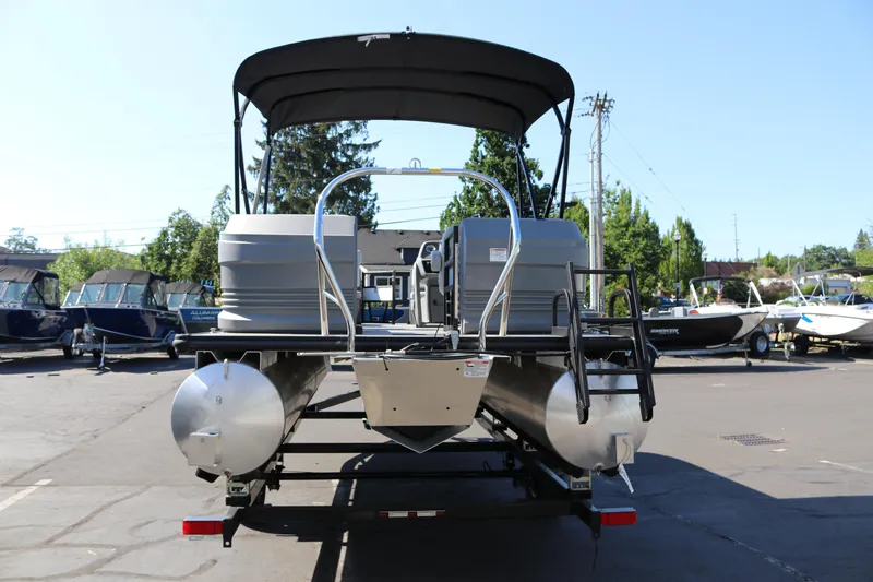 Slide: The Image of 2025 SunChaser Lucerne 20 LR DH pontoon boat on trailer, parked outdoors. - 6